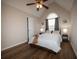 Bright bedroom boasts hardwood floors, ceiling fan, vaulted ceilings and natural light from the large window at 1412 Shelnutt Ct, Hampton, GA 30228