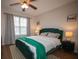 Cozy bedroom with hardwood floors, ceiling fan, window, and decor throughout at 1412 Shelnutt Ct, Hampton, GA 30228