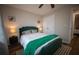 Bedroom with hardwood floors, plush bed, night stands with lamps, and closet at 1412 Shelnutt Ct, Hampton, GA 30228