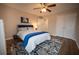 Bedroom with ceiling fan, hardwood floors, blue accents, and a double door closet at 1412 Shelnutt Ct, Hampton, GA 30228
