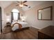 Bedroom with vaulted ceilings, hardwood floors, neutral walls, ceiling fan, and decor throughout at 1412 Shelnutt Ct, Hampton, GA 30228