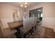 Dining room offers a hardwood table with chairs, wainscoting and stylish chandelier at 1412 Shelnutt Ct, Hampton, GA 30228