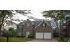 Charming two-story brick home featuring a two-car garage and well-manicured lawn at 1412 Shelnutt Ct, Hampton, GA 30228