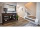 Inviting foyer showcasing hardwood floors, staircase, and stylish console table at 1412 Shelnutt Ct, Hampton, GA 30228