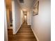 Hallway with hardwood floors and neutral walls leading to the bedrooms and bathrooms at 1412 Shelnutt Ct, Hampton, GA 30228