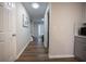 Well lit hallway with hardwood floors leads to the front door and other rooms at 1412 Shelnutt Ct, Hampton, GA 30228
