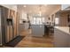 Modern kitchen with gray and white cabinets, stainless steel appliances, hardwood flooring, and marble countertops at 1412 Shelnutt Ct, Hampton, GA 30228