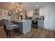 Modern kitchen with gray and white cabinets, stainless steel appliances, hardwood flooring, and marble countertops at 1412 Shelnutt Ct, Hampton, GA 30228