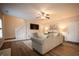 Comfortable living room with hardwood floors, a staircase, and a view of the front door at 1412 Shelnutt Ct, Hampton, GA 30228