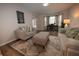 Cozy living room with ample seating, neutral color palette, and stylish decor at 1412 Shelnutt Ct, Hampton, GA 30228