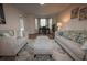 Spacious living room with neutral colored furnishings, bay window and hardwood floor at 1412 Shelnutt Ct, Hampton, GA 30228