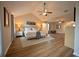 Expansive main bedroom featuring tray ceiling, ceiling fan, modern flooring, and lots of natural light at 1412 Shelnutt Ct, Hampton, GA 30228