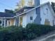 The side of the home shows white vinyl siding, a chimney, and boarded windows at 29 Park Ne Cir, Atlanta, GA 30305
