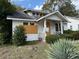 Two-story white house with chimney, small porch, and shrubbery at 29 Park Ne Cir, Atlanta, GA 30305