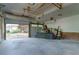 A bright garage with an open garage door features storage for the new homeowner at 3485 Aubusson Trce, Johns Creek, GA 30022