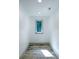 Hallway with a small window and tile flooring at 3485 Aubusson Trce, Johns Creek, GA 30022