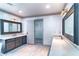 Bright bathroom with dual sinks, decorative mirrors, and lighting over tile floors at 3485 Aubusson Trce, Johns Creek, GA 30022