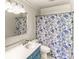 Bathroom with blue vanity and blue and white flower shower curtain at 3485 Aubusson Trce, Johns Creek, GA 30022