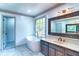 Updated bathroom featuring a soaking tub, vanity with updated finishes, and natural light at 3485 Aubusson Trce, Johns Creek, GA 30022