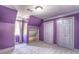 A purple bedroom with built-in closet, large closet doors, carpet, and window at 3485 Aubusson Trce, Johns Creek, GA 30022