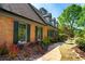 A brick home featuring dark shutters, complemented by manicured landscaping and a charming walkway at 3485 Aubusson Trce, Johns Creek, GA 30022