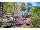 Beautifully landscaped yard surrounds this brick home with orange front door and an inviting curb appeal at 3485 Aubusson Trce, Johns Creek, GA 30022