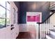 Entryway boasts hardwood floors, striking navy blue walls, and a staircase leading to the upper level at 3485 Aubusson Trce, Johns Creek, GA 30022