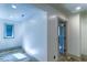 Cozy hallway with white walls, gray trim, recessed lighting, and a window at the end at 3485 Aubusson Trce, Johns Creek, GA 30022
