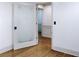 Hallway with an ornate pantry door and hardwood floors leading to another room at 3485 Aubusson Trce, Johns Creek, GA 30022