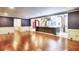 Open floor plan showcasing hardwood floors, kitchen island, and brick kitchen beyond cased opening at 3485 Aubusson Trce, Johns Creek, GA 30022