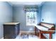 Sitting area with decorative window, a countertop cabinet, and an antique desk with storage beneath at 3485 Aubusson Trce, Johns Creek, GA 30022