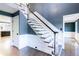 A hardwood staircase with white trim and gray-blue walls leads to other rooms in the house at 3485 Aubusson Trce, Johns Creek, GA 30022