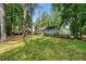 Landscaped backyard featuring expansive lawns and mature trees at 5873 Trellis Ct, Powder Springs, GA 30127