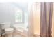 Bright bathroom showcasing a shower with curtain and a garden tub at 5873 Trellis Ct, Powder Springs, GA 30127
