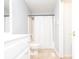 Well-lit bathroom featuring a shower and sink at 5873 Trellis Ct, Powder Springs, GA 30127