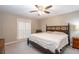 A comfortable bedroom featuring a ceiling fan and a large bed at 5873 Trellis Ct, Powder Springs, GA 30127