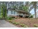 Charming home featuring brick accents, a cozy front porch, and a well-manicured lawn at 5873 Trellis Ct, Powder Springs, GA 30127