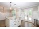 The kitchen island has bar seating and double doors leading outside for indoor/outdoor living at 5873 Trellis Ct, Powder Springs, GA 30127