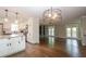 Open-concept kitchen with granite countertops seamlessly connecting to the living room area at 5873 Trellis Ct, Powder Springs, GA 30127