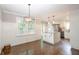 Modern kitchen includes a center island, contemporary lighting, and stainless steel appliances at 5873 Trellis Ct, Powder Springs, GA 30127