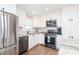 Well-equipped kitchen boasting stainless steel appliances, granite countertops, and ample cabinetry at 5873 Trellis Ct, Powder Springs, GA 30127