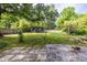 Large backyard with string lights, modern shed, mature trees, and a patio area, perfect for outdoor gatherings at 991 Columbia Dr, Decatur, GA 30030