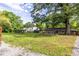 Extensive backyard showcasing the home's exterior, a large lawn, mature trees, and outbuildings at 991 Columbia Dr, Decatur, GA 30030
