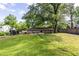Spacious backyard with lush lawn, mature trees, and house at 991 Columbia Dr, Decatur, GA 30030