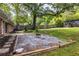 Backyard featuring a fire pit with a gravel area, mature trees and grass at 991 Columbia Dr, Decatur, GA 30030