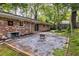 A backyard with a patio, gravel area with fire pit, and mature trees at 991 Columbia Dr, Decatur, GA 30030