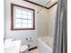 Classic bathroom with decorative tub and shower, and marble flooring at 991 Columbia Dr, Decatur, GA 30030