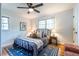 Cozy bedroom with hardwood floors, comfortable queen bed, and natural light from multiple windows at 991 Columbia Dr, Decatur, GA 30030