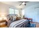 Sunlit bedroom with a queen bed, hardwood floors, and ample natural light from large windows at 991 Columbia Dr, Decatur, GA 30030