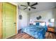 A cozy bedroom boasts wood floors, a ceiling fan, and a green door with natural wood trim at 991 Columbia Dr, Decatur, GA 30030